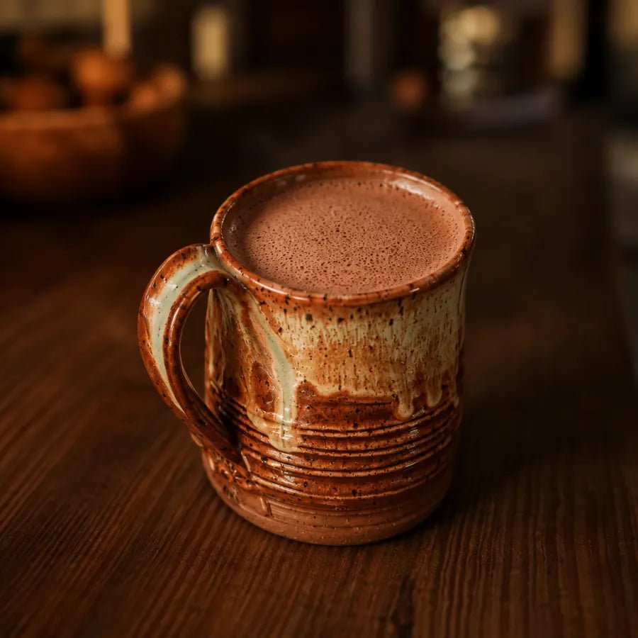 A mug of frothed cacao with a thick layer of fine foam